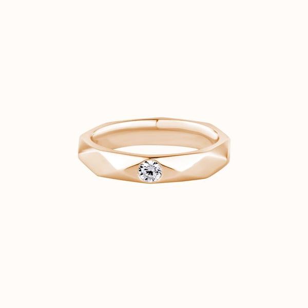 A faceted rose gold band set with a single diamond
