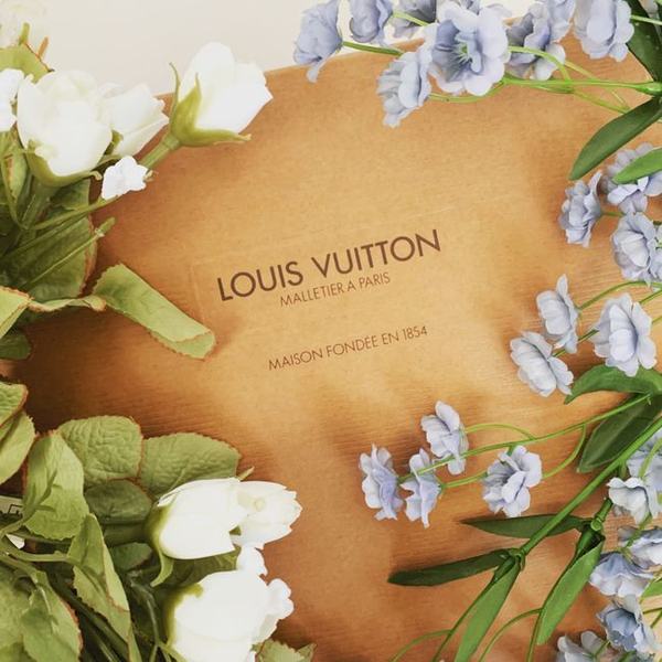Louis Vuitton wrapping surrounded by white and blue flowers