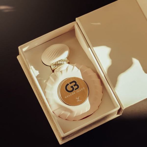 A fragrance bottle seated in its presentation box