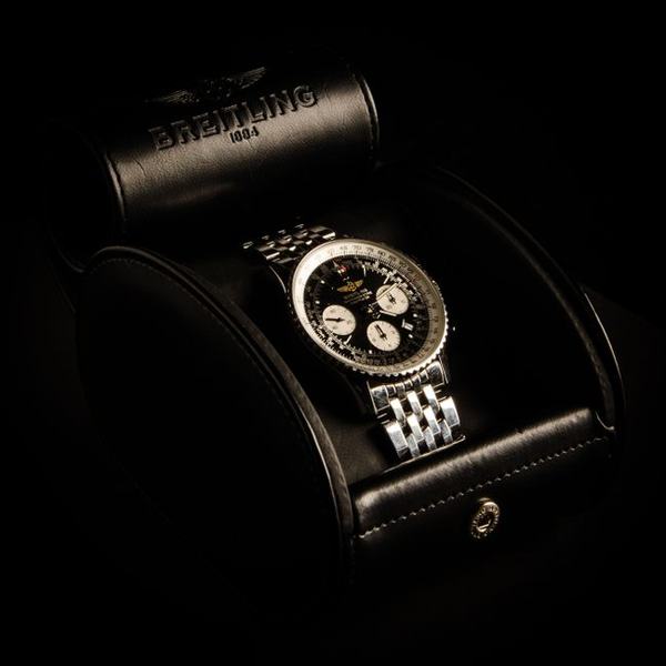 A chronograph watch in a black leather travel case