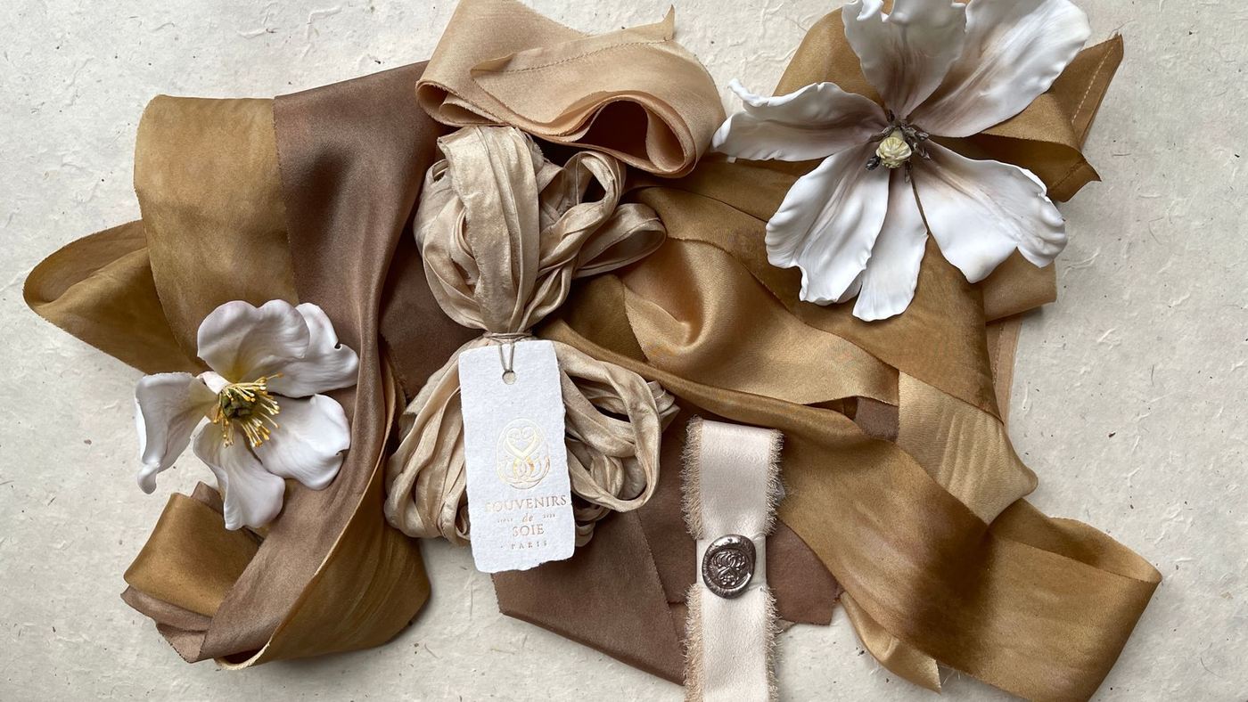 Silk ribbons in cream and tan with a wax-sealed tag