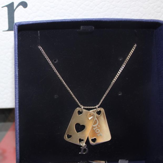 A Dior charm necklace with cut-out hearts, presented in its navy box