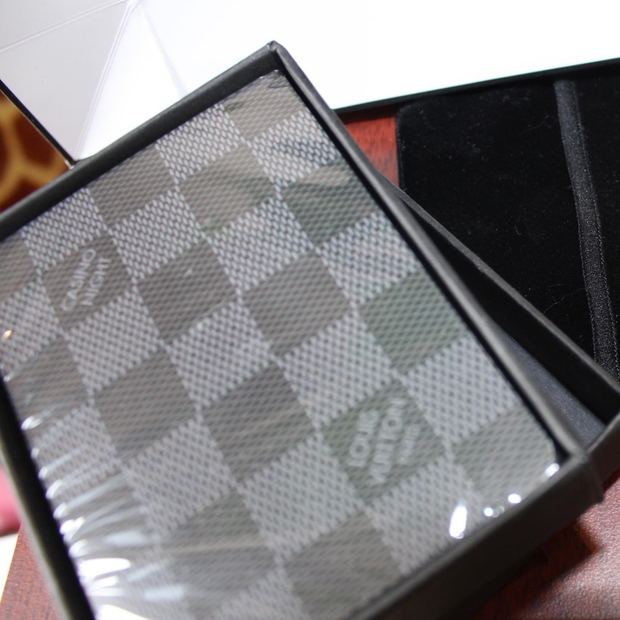 A sealed Louis Vuitton Damier Graphite playing card set in a black presentation box